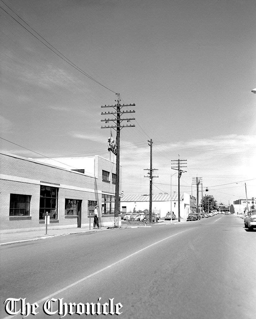 From the June 1959 Chronicle archives:  “POLES COMING DOWN - Since 1908 this long distance telephone line has been a familiar sight along Pearl street in Centralia. Monday a Pacific Telephone crew was taking down the 40 wires, most of them iron, and shortly the poles will go, too. Upper lines, for old city fire alarm system, were also removed. View is in 300 black of North Pearl street, with Daily Chronicle building in left background - Chronicle Staff Photo.”